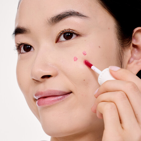 Model applying Benetint to cheek