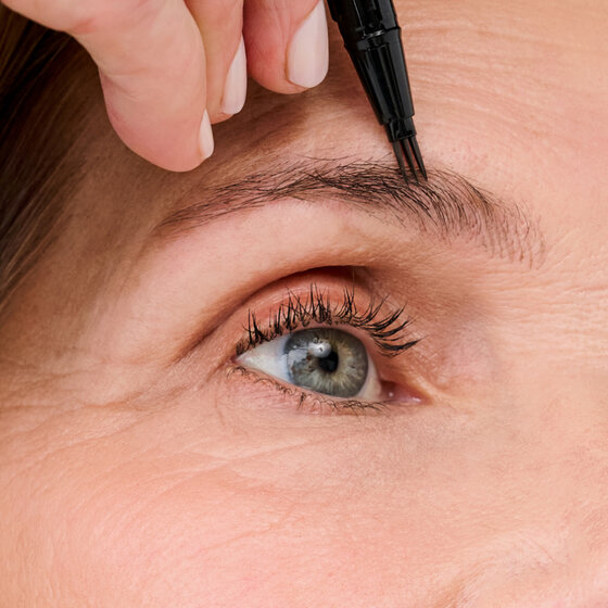 Model applying Mighty Fine Brow Pen