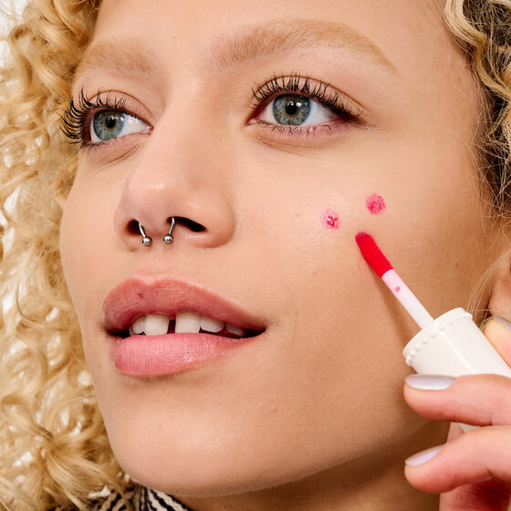 model dots product onto cheek